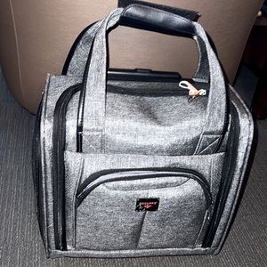 Dockers small carry on suitcase with wheels and a lot of pockets. Only used once
